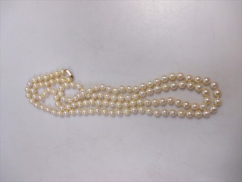 Lot 193 - A string of pearls, a 9ct gold clasp and a 9ct gold ring.
