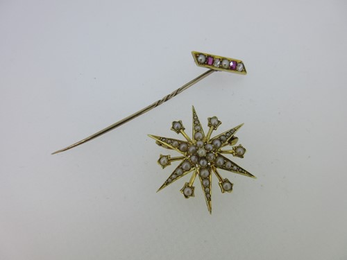 Lot 93 - A ruby,  diamond and seed pearl stick pin together with a seed pearl star brooch