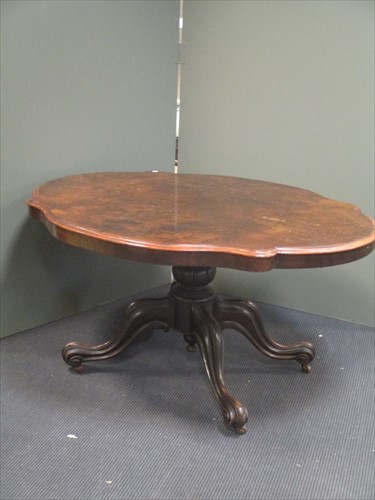 Lot 642 - A Victorian walnut loo table on quad moulded...