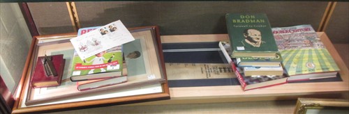 Lot 9 - A 2009 Ashes cricket bat, signed together with various books and 2 Spy cricketing prints