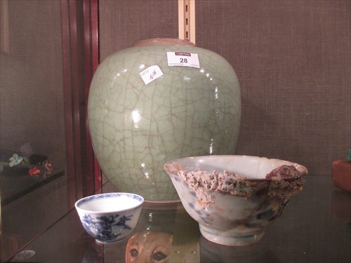 Lot 28 - A Celadon oval jar, lacking lid, 22cm high...
