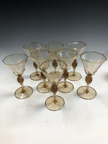 Lot 17 - MVM Cappellin, Murano, a set of eight amber glass wine glasses, circa 1925