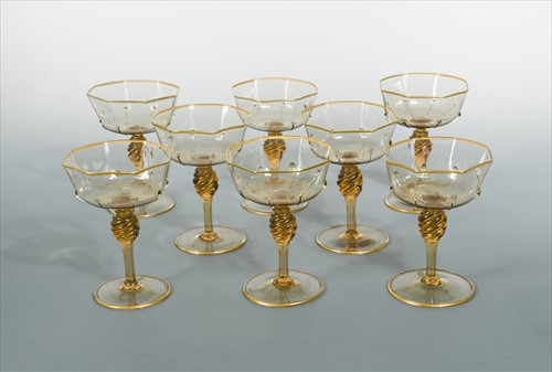Lot 18 - MVM Cappellin, Murano, a set of eight amber glass champagne bowls, circa 1925