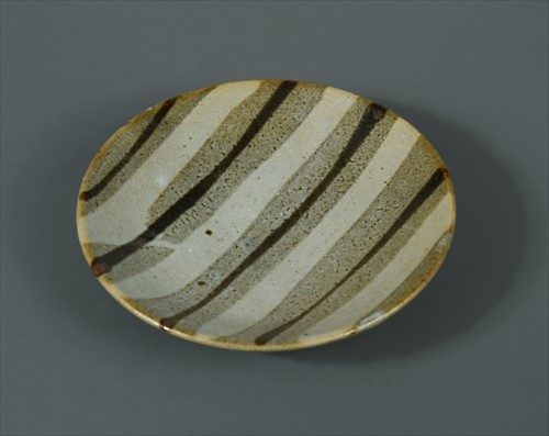Lot 51 - Shoji Hamada (Japanese, 1894-1978), a Nuka glazed plate
