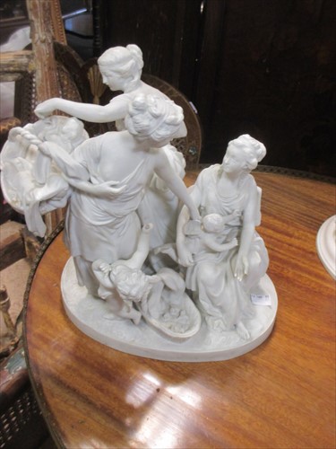 Lot 60 - A 19th century bisque porcelain group of three...