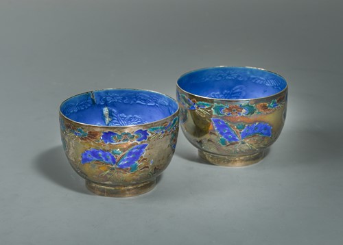 Lot 134 - A pair of Chinese silver and blue enamel cups, early 20th century