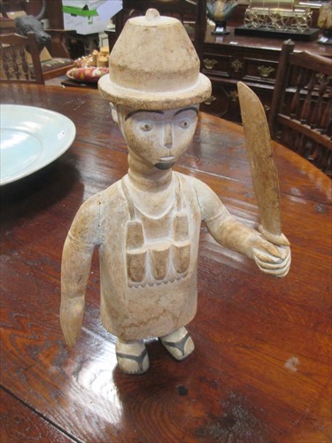 Lot 507 - An African carved figure of a European holding...