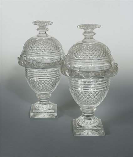 Lot 8 - A pair of Irish Regency glass vases and covers