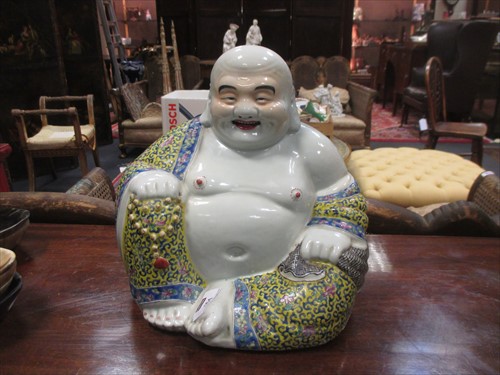 Lot 101 - A 20th century porcelain figure of a seated...