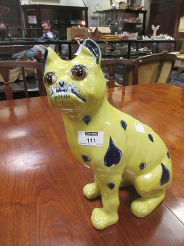 Lot 111 - A Galle type yellow glazed bulldog with glass eyes