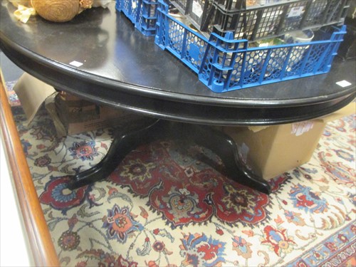 Lot 474 - A black painted circular breakfast table on...