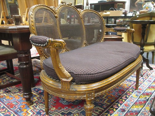 Lot 566 - A Louis XV style carved beech wood canape,...