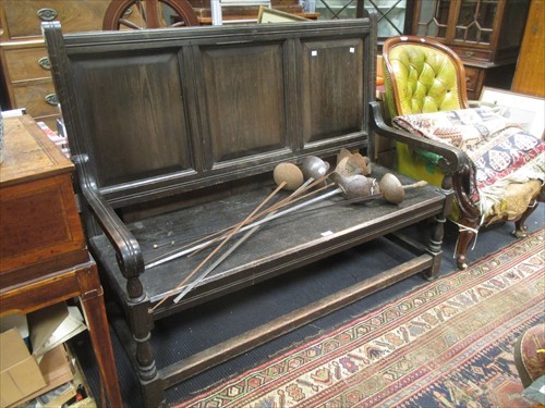 Lot 551 - A late 19th century ebonised oak hall settle...