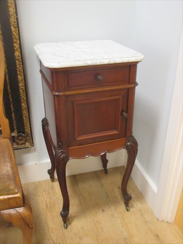 Lot 598 - A pair of French mahogany bedsides with white marble tops.