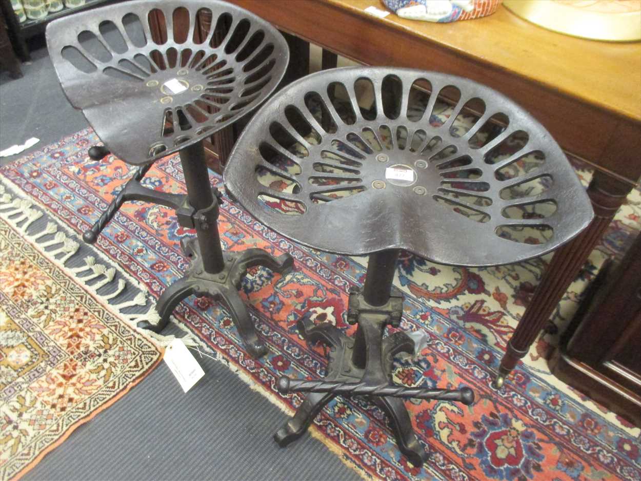 Lot 477 - A pair of cast iron adjustable bar stools with...