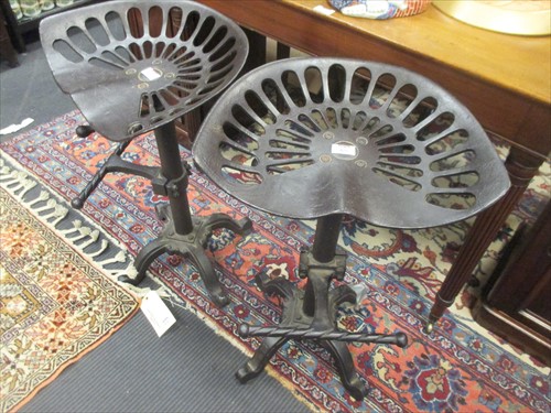 Lot 477 - A pair of cast iron adjustable bar stools with...