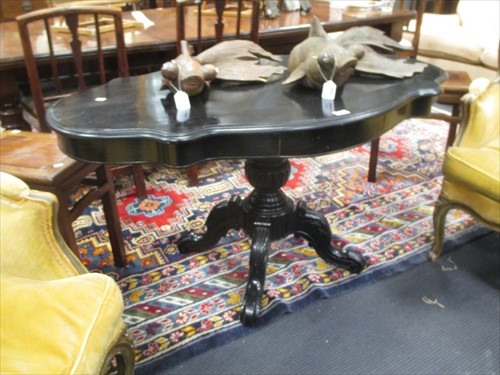 Lot 572 - A black painted shaped oval tilt top breakfast...