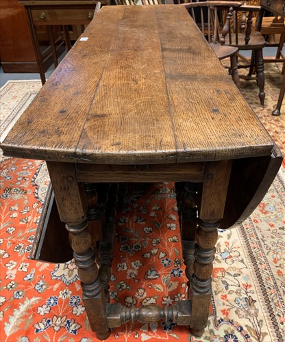 Lot 633 - An 18th century oak gateleg dining table the...