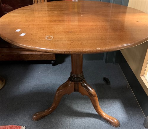 Lot 647 - A George III mahogany tilt top wine table on...