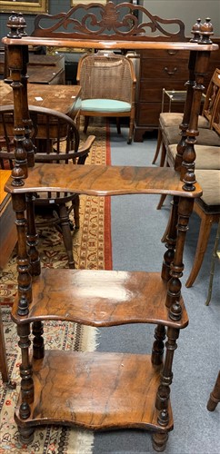 Lot 654 - A Victorian walnut four tier what not with...