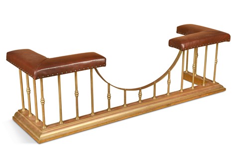 Lot 581 - A Victorian style brass and leather seated club fender, late 20th century