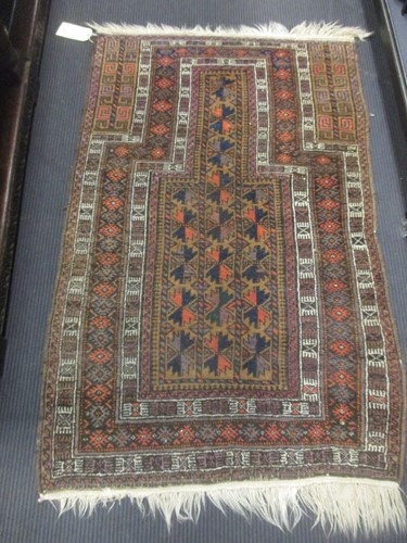 Lot 550 - A Belouchi prayer rug woven in the tradional...