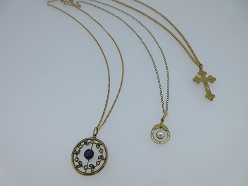 Lot 128 - A trio of pendants with chains