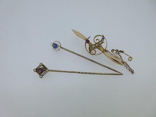 Lot 129 - Two seed pearl and gemset stick pins and a similar brooch
