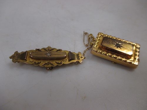 Lot 183 - Two diamond set memorial brooches