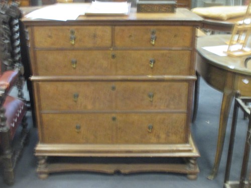 Lot 517 - A walnut chest of drawers on later stand,...