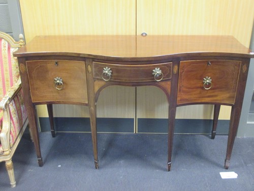 Lot 305 - A George III mahogany serpentine sideboard,...