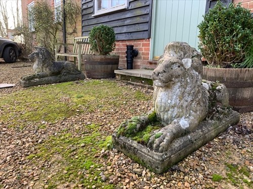Lot 441 - A pair of reconstituted stone recumbent lions, 20th century