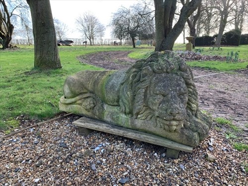 Lot 439 - A pair of large reconstituted stone recumbent lions, 20th century