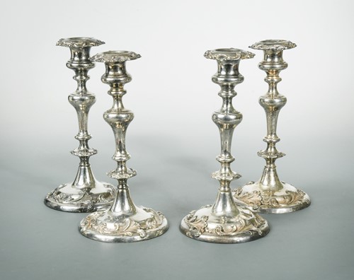 Lot 373 - A set of four silver plated on copper candlesticks