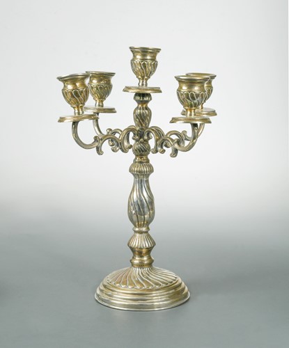 Lot 390 - A Greek metalwares four branch five light candelabra