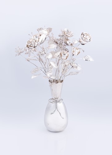 Lot 355 - A Greek metalwares vase containing a spray of flowers