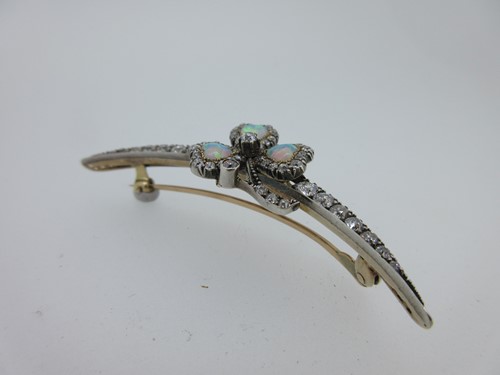 Lot 256 - An antique diamond crescent and opal shamrock brooch