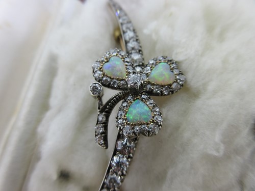 Lot 256 - An antique diamond crescent and opal shamrock brooch