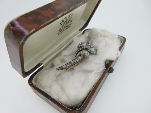 Lot 256 - An antique diamond crescent and opal shamrock brooch