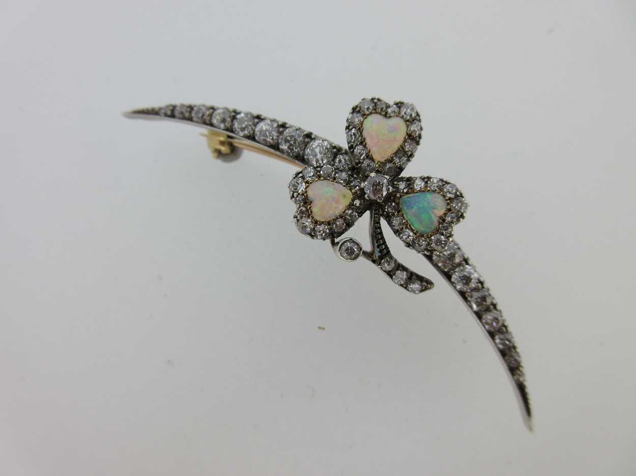 Lot 256 - An antique diamond crescent and opal shamrock brooch