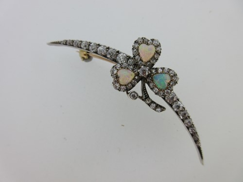 Lot 256 - An antique diamond crescent and opal shamrock brooch