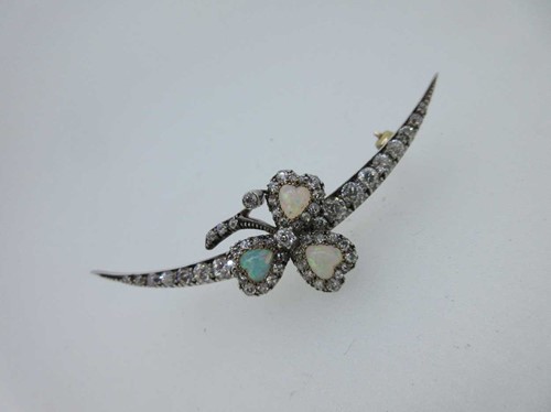 Lot 256 - An antique diamond crescent and opal shamrock brooch