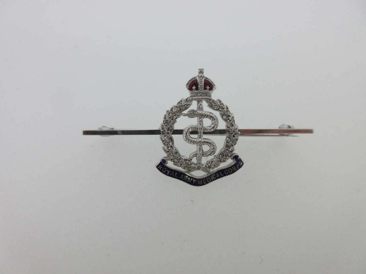 Lot 100 - A diamond and enamel Royal Army Medical Corps brooch
