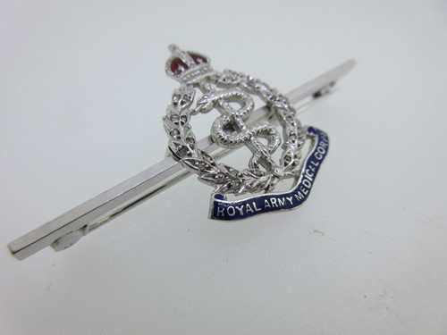 Lot 100 - A diamond and enamel Royal Army Medical Corps brooch