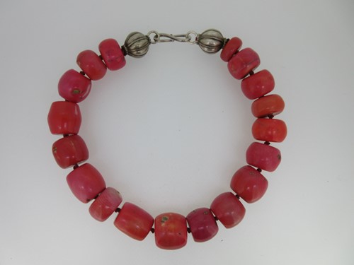 Lot 113 - A vintage necklace of large coral beads with two cantaloupe beads