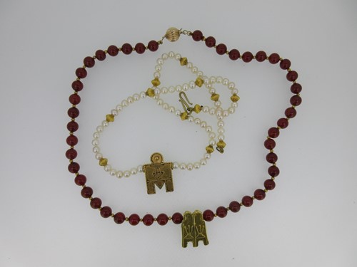 Lot 3 - A cultured pearl necklace and a cornelian necklace each set with a Tamil wedding thali