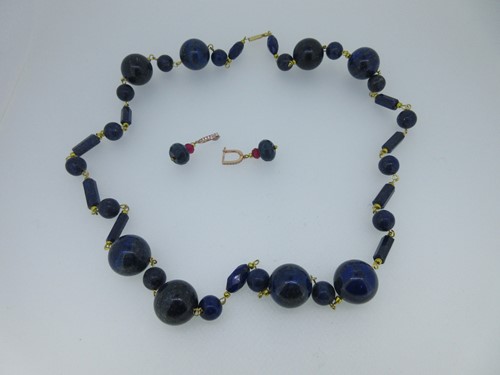 Lot 94 - A row of lapis lazuli beads together with a pair of ruby and diamond earpendants