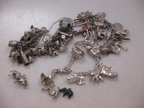 Lot 179 - Three 'silver' charm bracelets and a quantity of loose charms