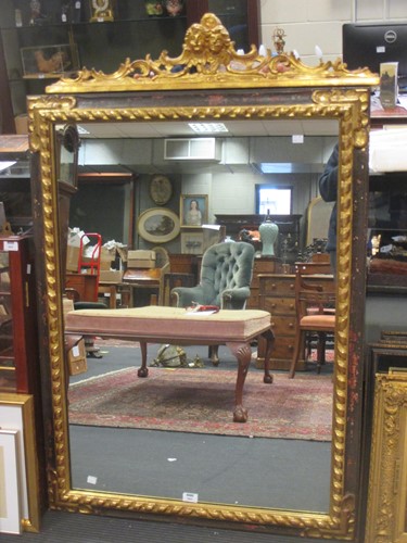 Lot 543 - An Italian parcel gilt wall mirror, with twin...