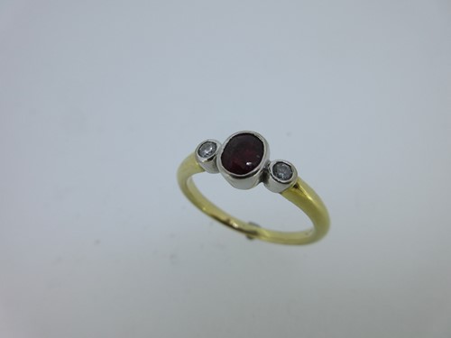 Lot 132 - A ruby and diamond three stone ring
